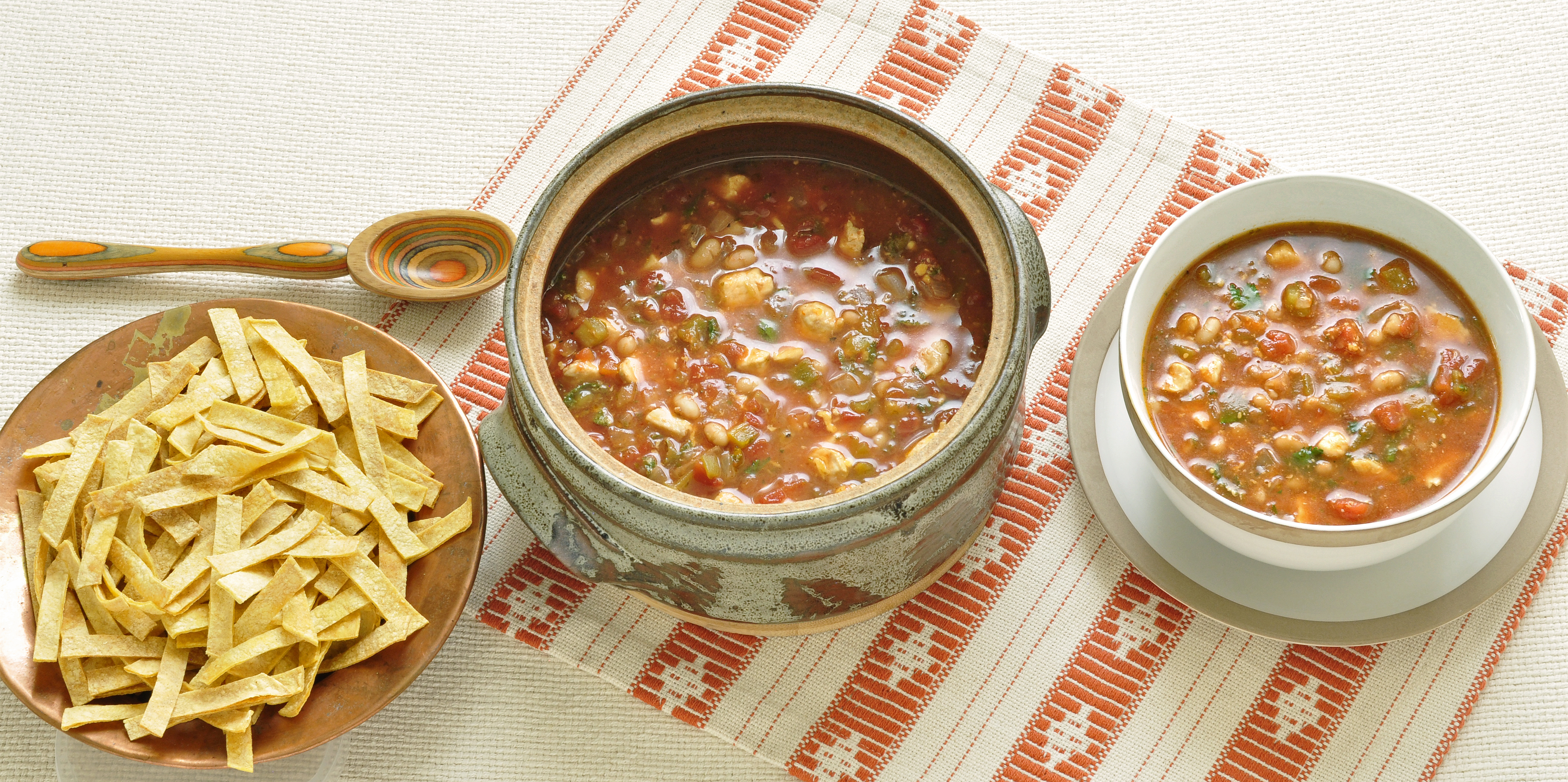 Chicken soup with tortilla served on table 