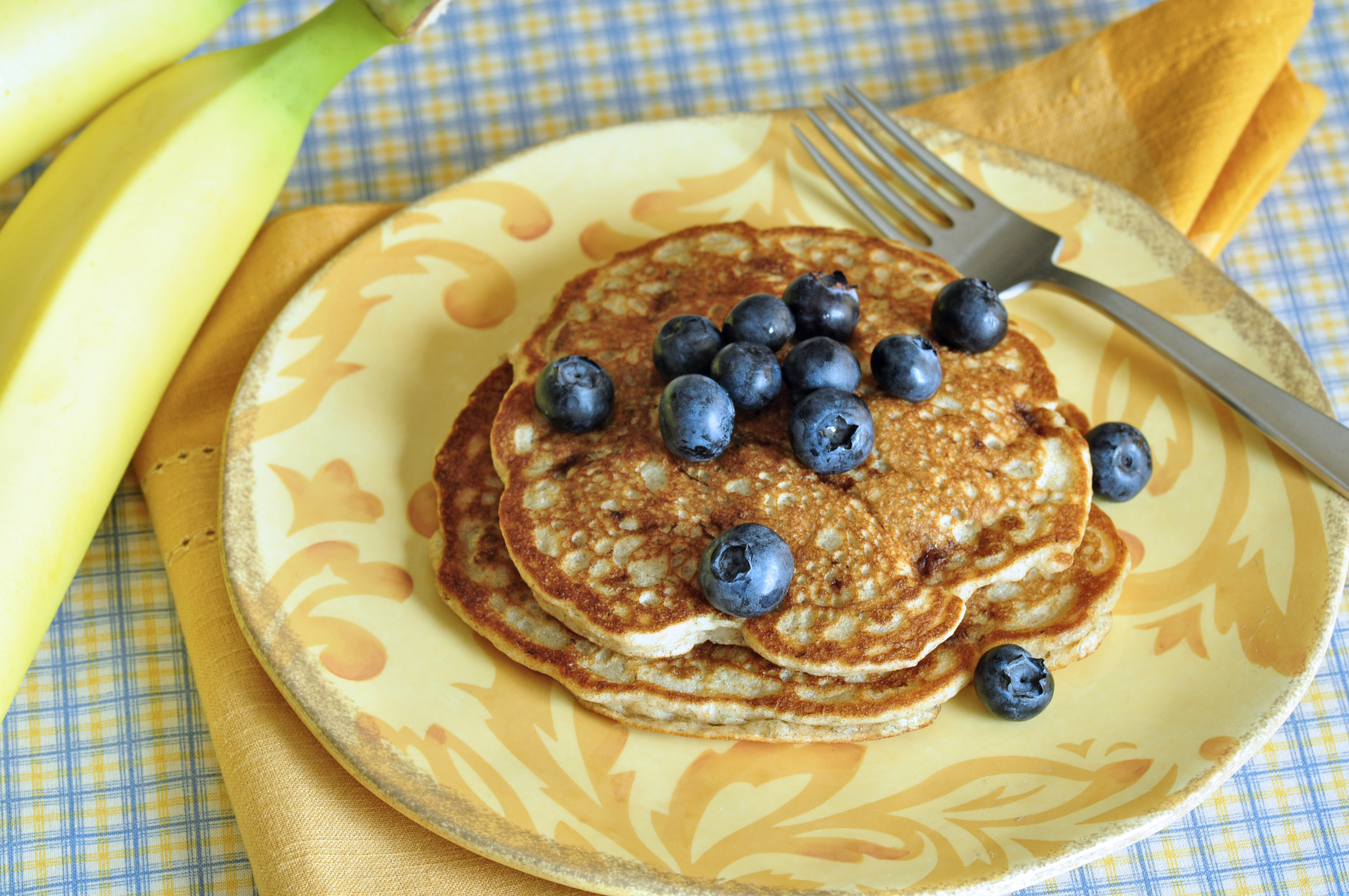 Banana Pancakes Served on plate, topped with fresh berries