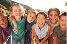 Six kids looking at the camera and smiling.