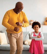 older man dancing with granddaughter