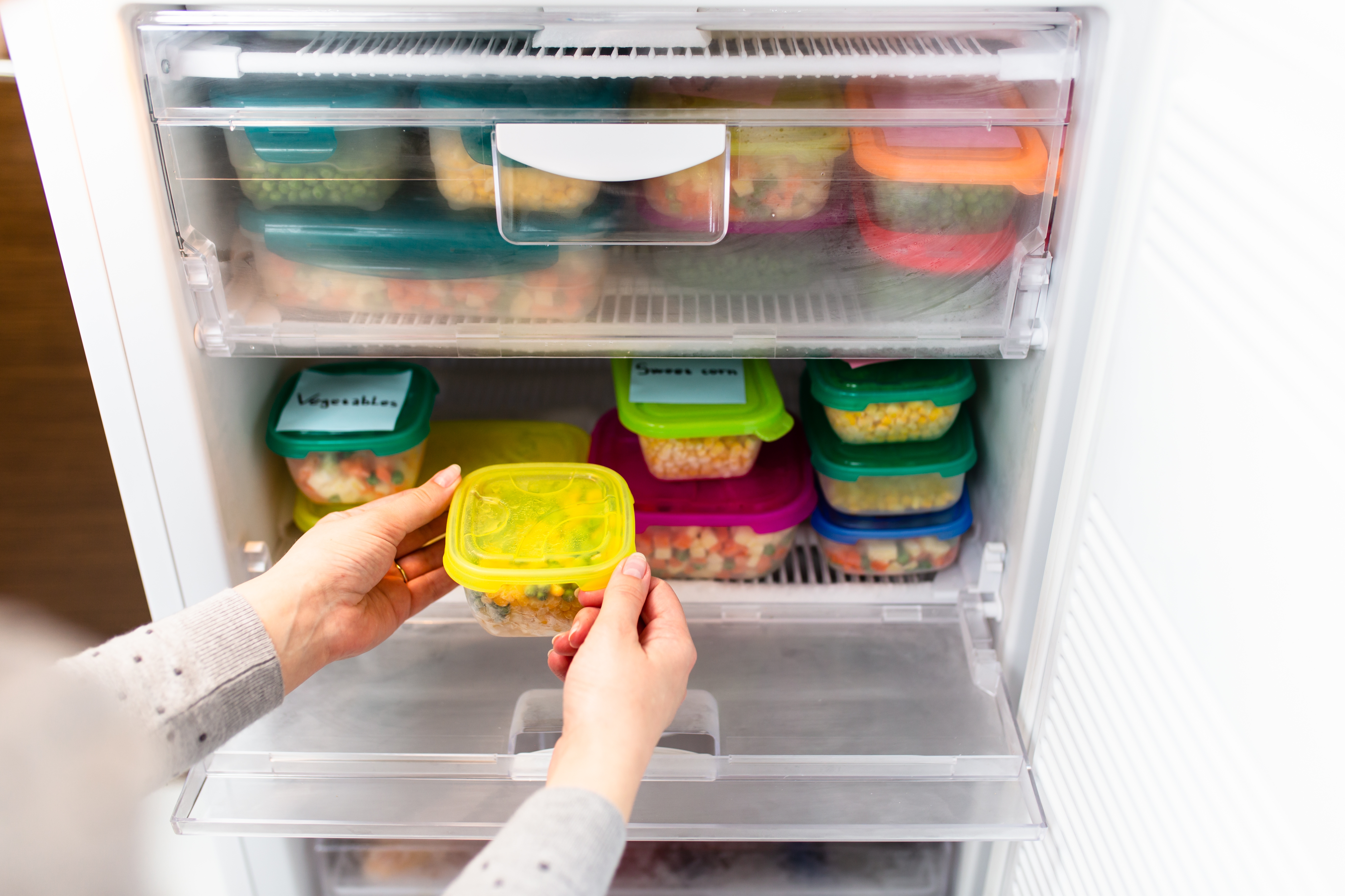 Containers of produce in freezer