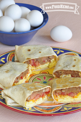 Flour tortillas are filled with beans, eggs, tomato and cheese and baked for a crispy outside.