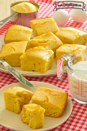 Square pieces of yellow cornbread on plates.