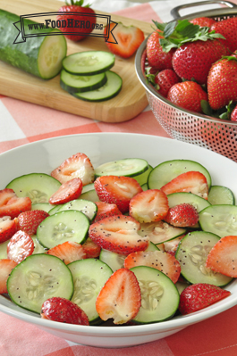 Strawberry and cucumber slices coated with poppy seed dressing.