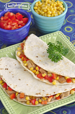 Plate of tortillas folded over a tuna, vegetable and cheese mix.