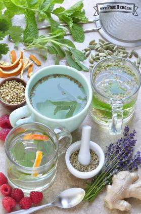 Mugs of water infused with herbs and orange peels.