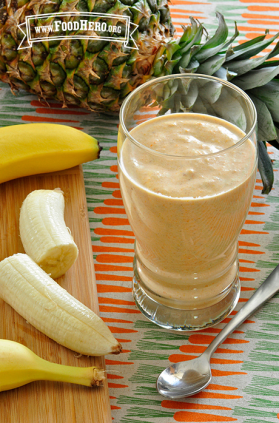 Glass filled with a thick orange smoothie.