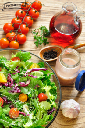 Jar of vinaigrette dressing served on a salad.