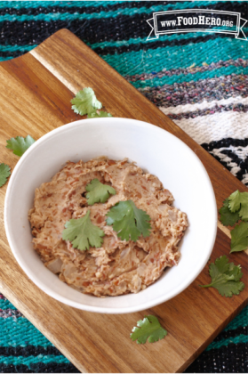 Small bowl of mashed beans garnished with cilantro.