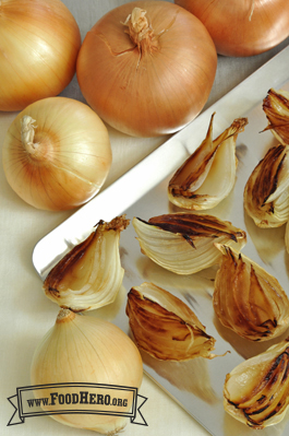 Caramelized onion quarters on a baking sheet. 