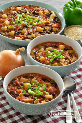 Colorful bowls of thick chili served with green onion.