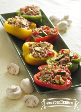 Platter of multicolored baked bell peppers stuffed with ground turkey, vegetables and mushrooms.