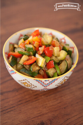 Small bowl with a tender zucchini and vegetable mix.