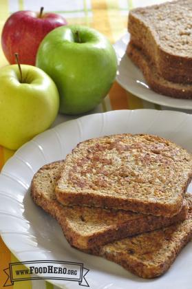 Slices of french toast cooked with applesauce, vanilla and cinnamon are displayed on a plate.