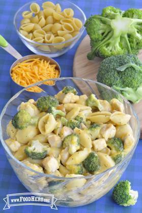 Bowl of cheesy pasta with broccoli florets.