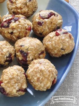 Plate of rolled balls of oats with dried cranberries.