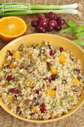 Large bowl of a colorful mix of bulgur, fruit and vegetables.