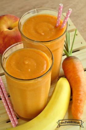 Glasses of a smooth, orange smoothie with straws.