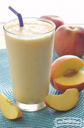 Glass filled a thick peach smoothie.