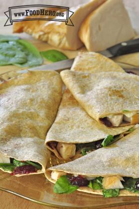 Plate of golden tortillas folded over turkey, cranberry and spinach filling. 