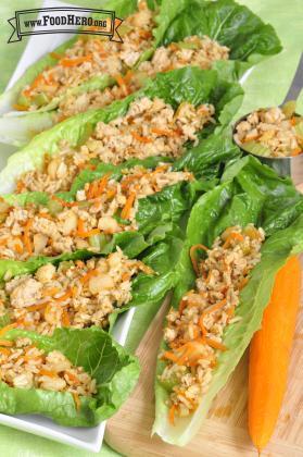 Plate of lettuce boats filled with a turkey and carrot mix.