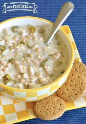 Small bowl of creamy chicken and bean soup served with crackers.