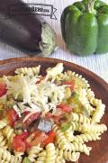 Rotini noodles with vegetables and shredded cheese.