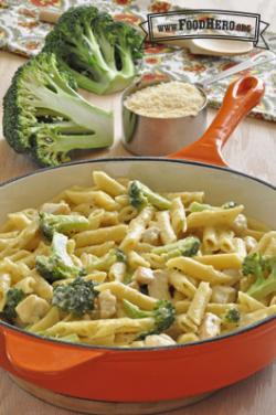 Creamy pasta and broccoli in a skillet.