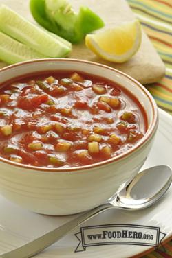 Small bowl of tomato based chunky vegetable soup.