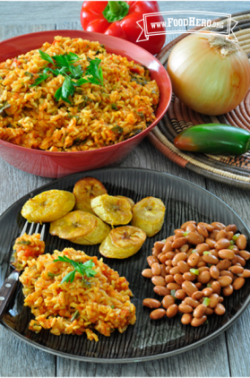 Big bowl of Jollof Rice shown served with plantains and beans.