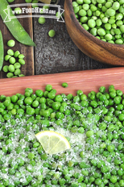 Platter of peas and parmesan with a lemon slice.