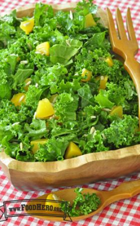 Wooden bowl holding a large Kale Salad.