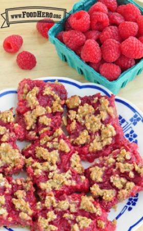 Plate of square red oatmeal and raspberry bars. 