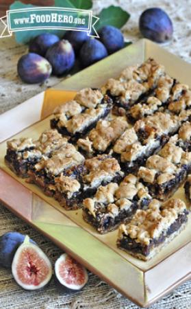 Oat bars with a gooey fig center on a serving platter.