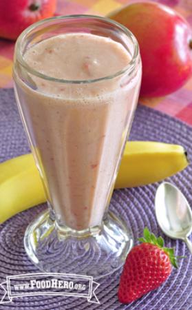 Fruit smoothie in a tall glass.