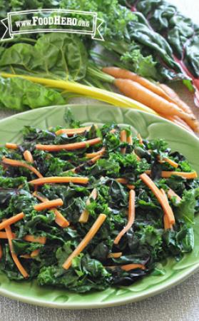 Plate of kale and carrot strips with dressing. 