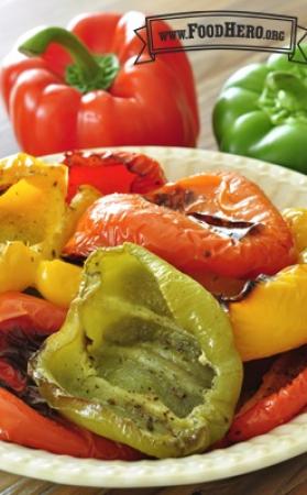 Multicolored bell pepper halves with blistered skin in a bowl. 