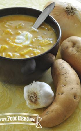 Bowl of orange, creamy soup with a dallop of sour cream 