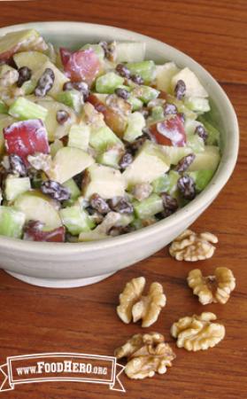 Bowl of creamy apple, celery and walnut mix.